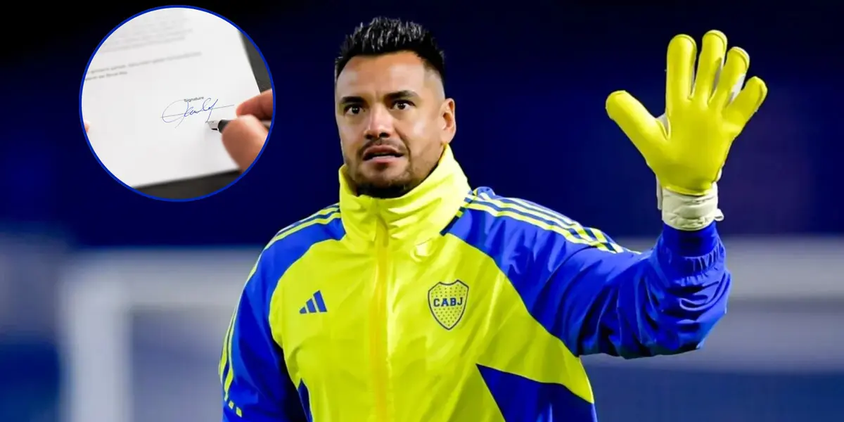 Sergio Romero luciendo una campera de Boca y sus guantes.